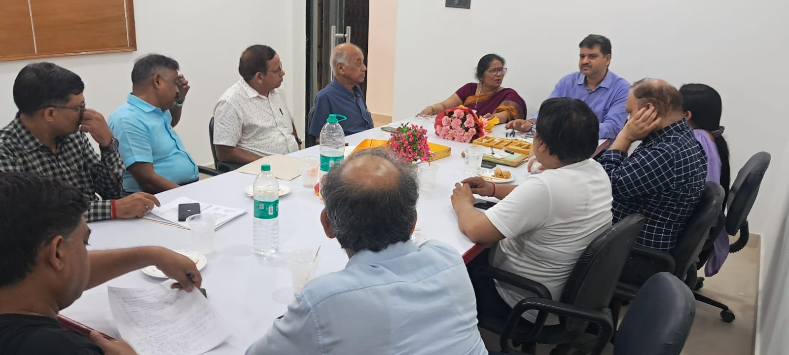 Members seated around the meeting table