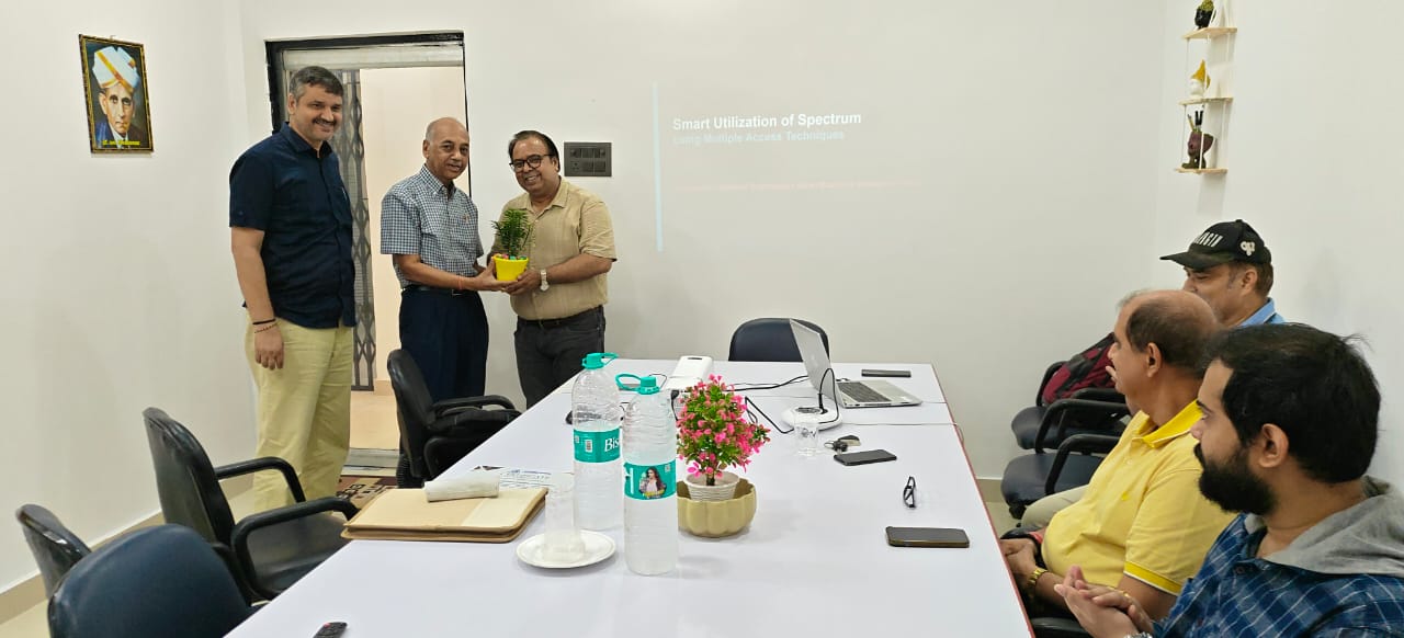 Attendees standing as a memento is presented during the ceremony